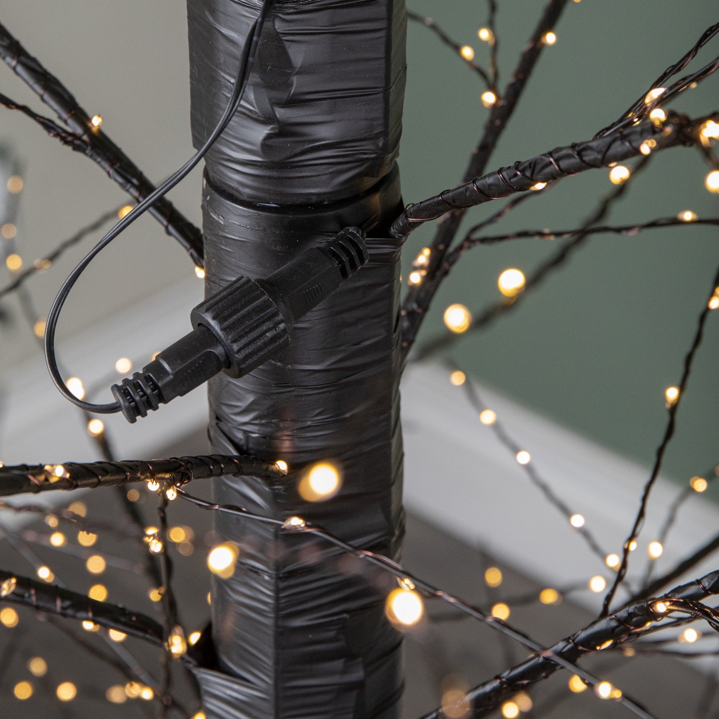 7ft (2.10m) Tall Light up Black Micro Dot Christmas Tree with 1600 Warm White LEDs