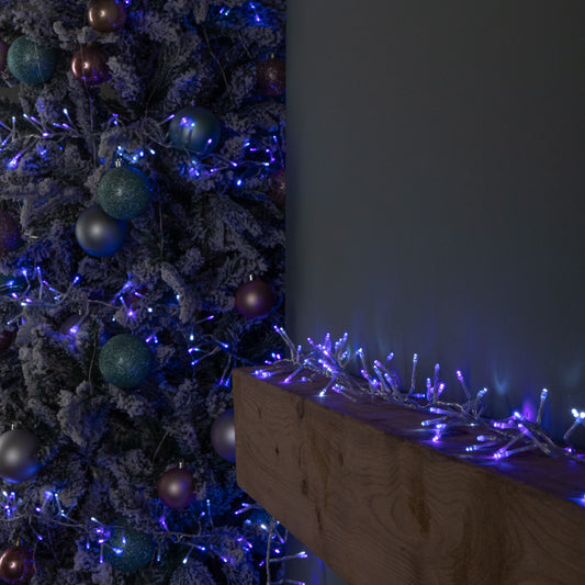 12.4m 960 LED Christmas Cluster Multi-Action String Lights with Timer in Blue, Purple & White on Clear Cable